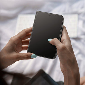 iPhone Duo GLAS.tR EZ Fit Pro | Privacy showing a foldable device held in both hands with the screen protector installed over the display.
