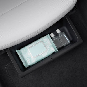 Spigen underseat organizer holding a bottle below a Tesla Model Y Juniper seat