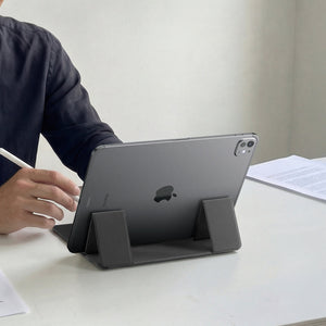 AMP11117 - Slim Fold Laptop Stand | Non-Adhesive | Black LD201-S8 showing back view of person using iPad propped up on laptop stand