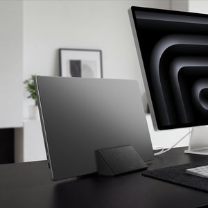 AMP11118 - Slim Fold Laptop Stand | Non-Adhesive | Black LD201-S9 showing MacBook laptop vertically mount to the laptop stand for storage