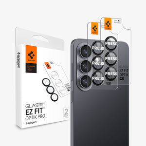 Spigen Galaxy S26 Optik EZ Fit Lens Pro Protector showing the 2 lens protector hovering in front of the device with the packaging behind it