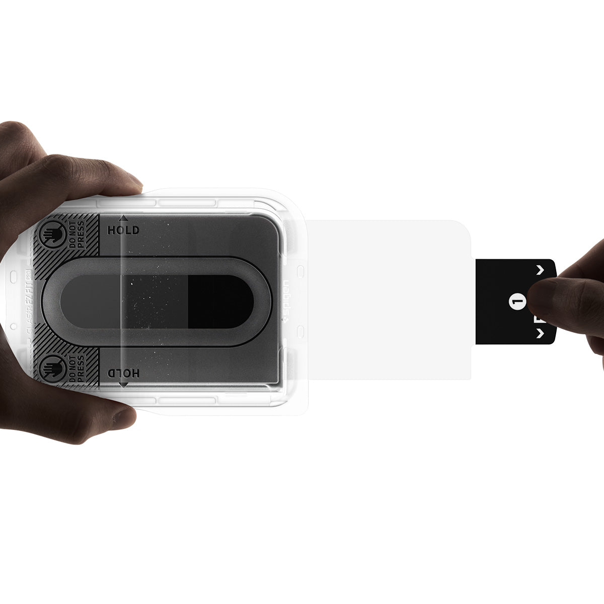 iPhone Duo GLAS.tR EZ Fit Pro | Privacy showing the pull tab being removed from the installation tray during the screen protector application process.
