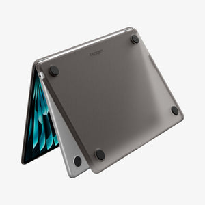 Spigen MacBook Air 13-inch Air Skin in Frost Black showing the bottom exterior with four rubber feet and the Spigen logo visible on a white background