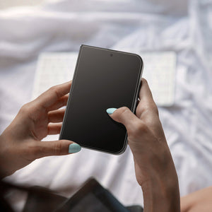 iPhone Duo Glas.tR EZ Fit Pro showing the screen protector applied to a foldable display during everyday use.
