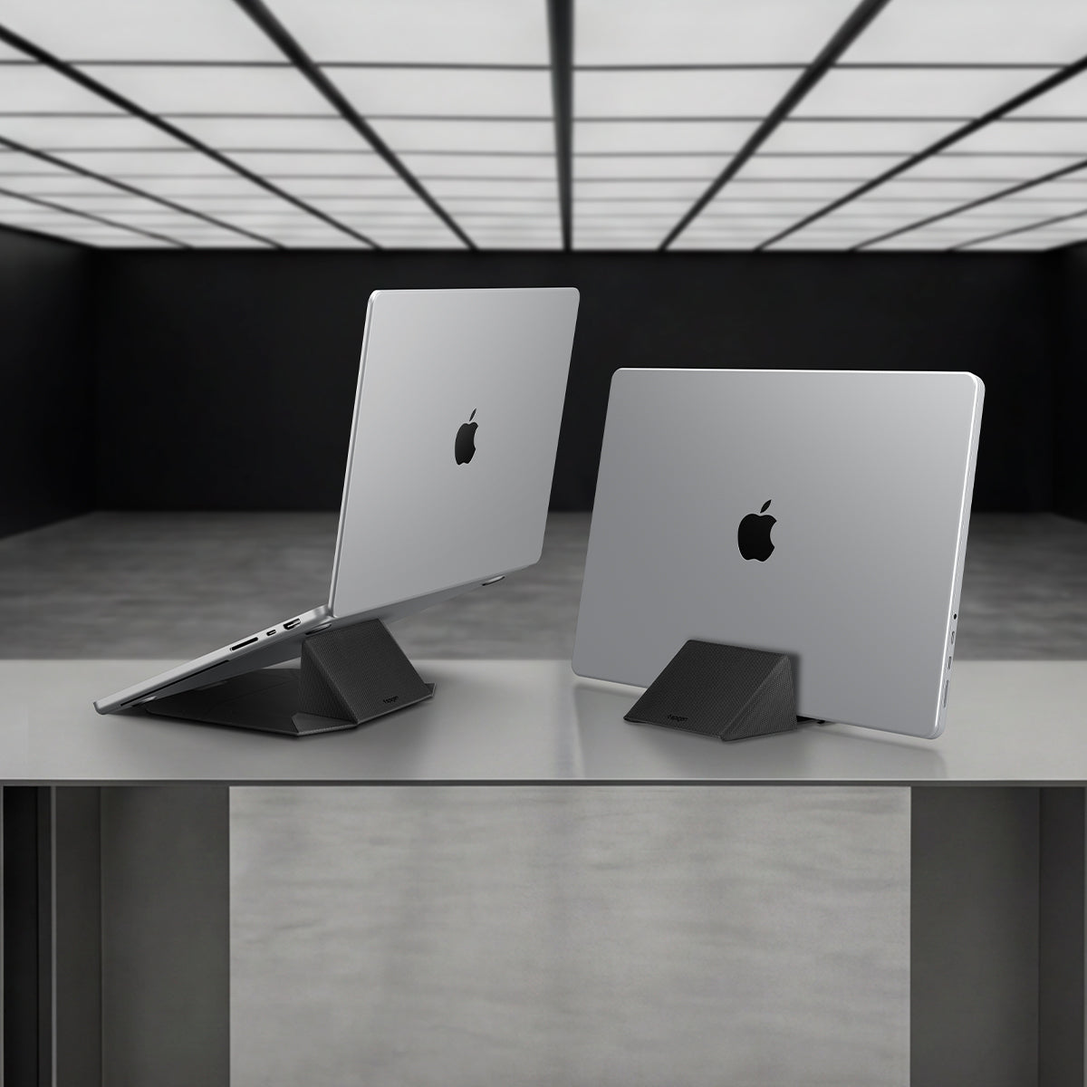 AMP11118 - Slim Fold Laptop Stand | Non-Adhesive | Black LD201-S9 showing one MacBook propped up for use and on the right MacBook vertically mount for storage