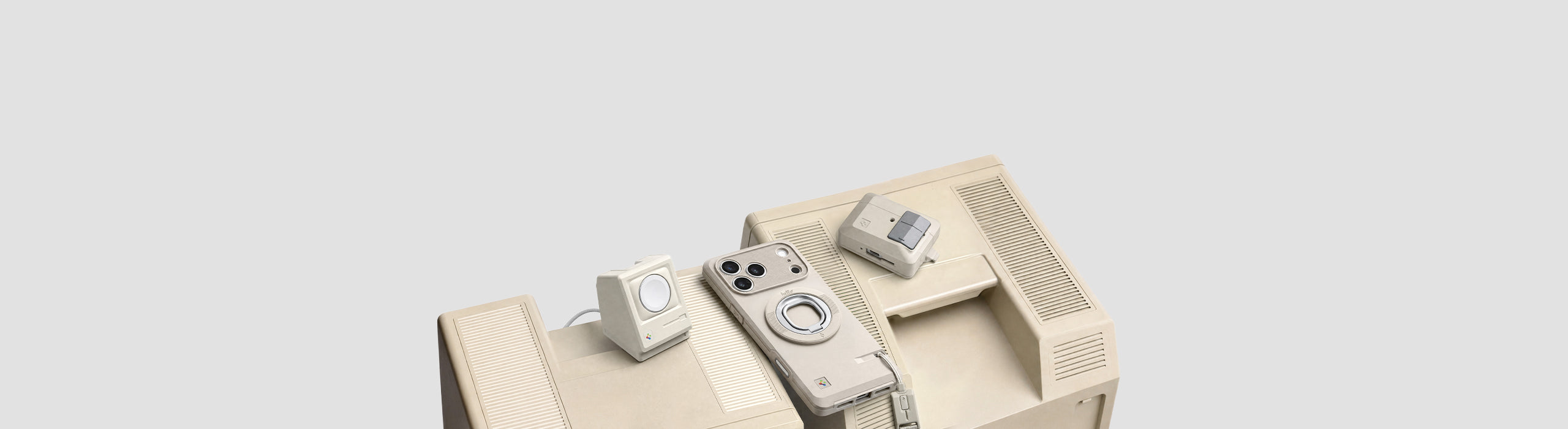 Retro beige Spigen Classic LS cases and charging accessories on a vintage Macintosh